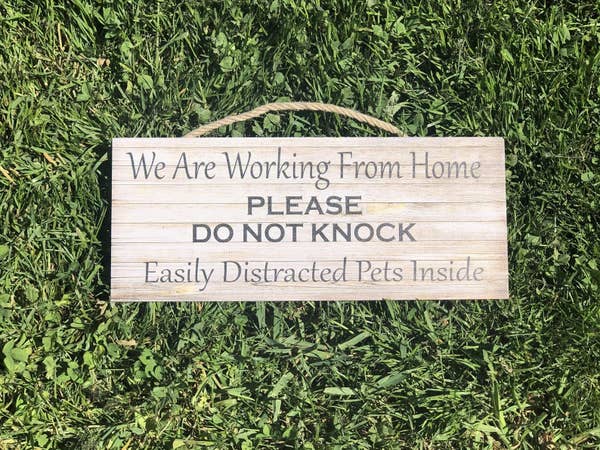 Wooden sign that says &quot;We are working from home, please do not knock, easily distracted pets inside&quot; 