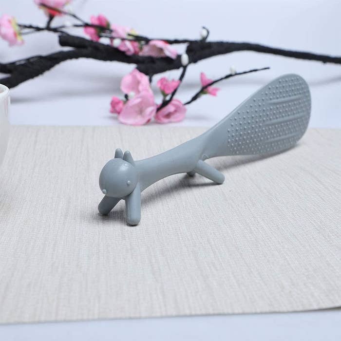 A close up of the squirrel shaped rice scoop placed neatly on a tabletop