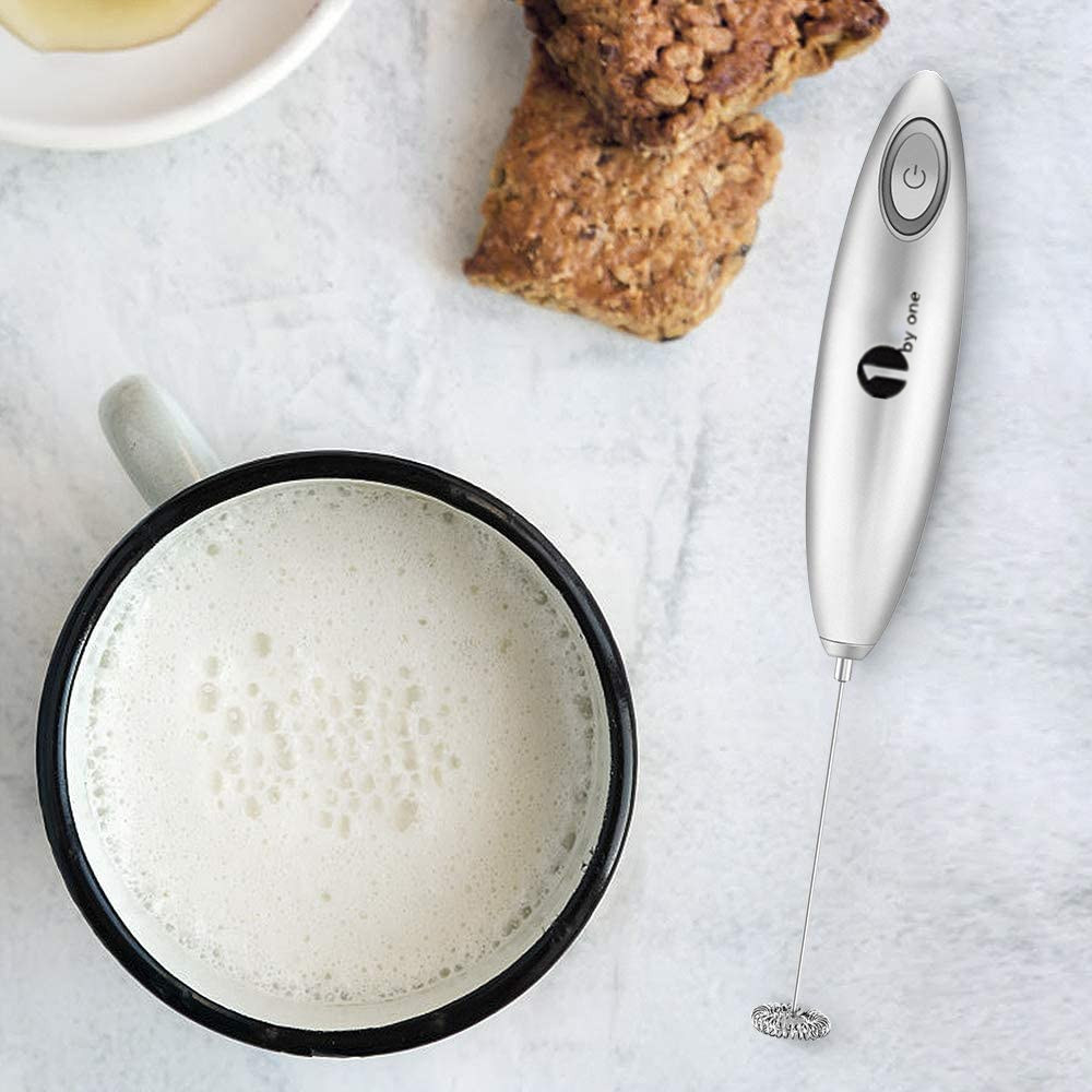 Product photo showing 1byone Milk Frother next to a mug of frothed milk