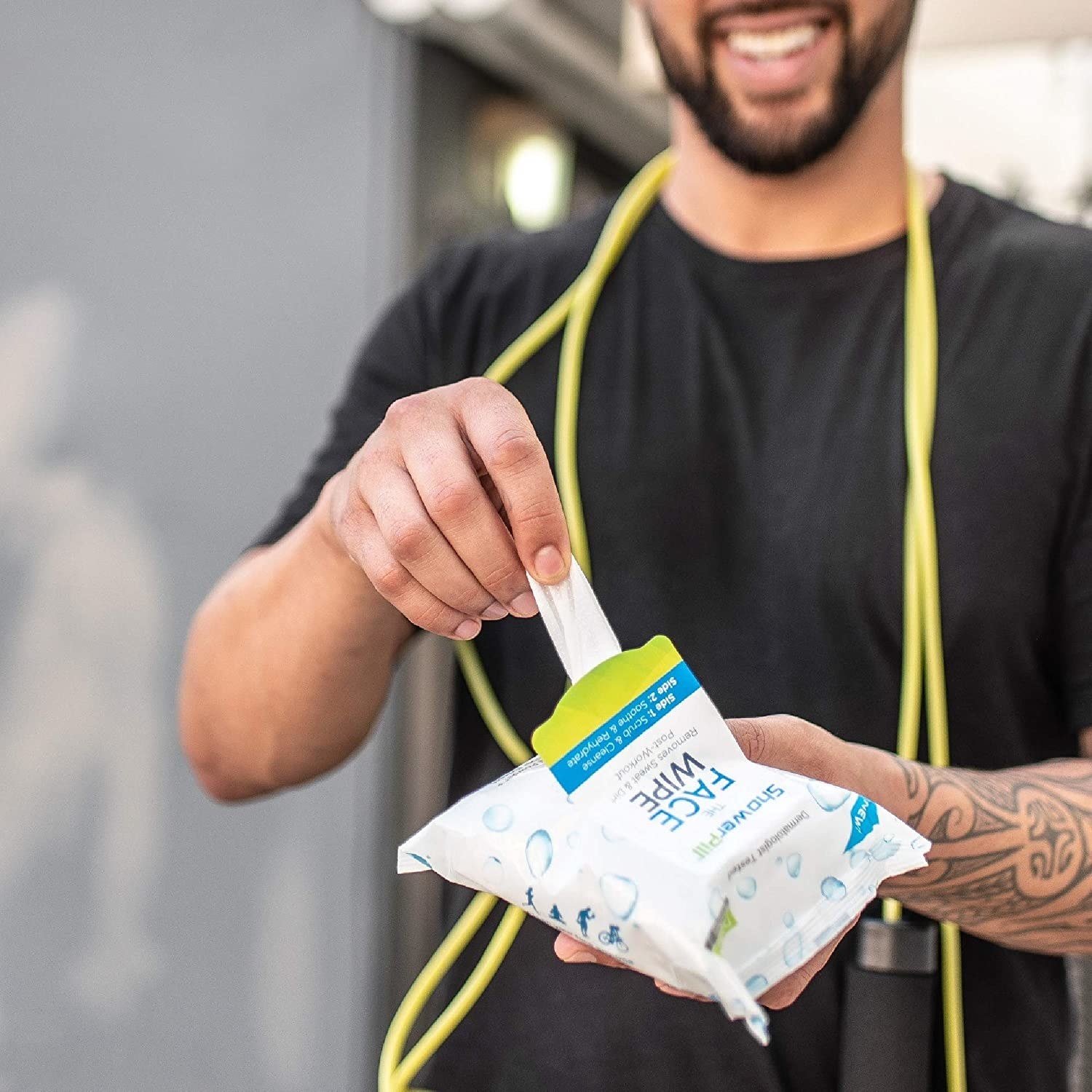 person post-workout with jumprope pulling a wipe out of the packet