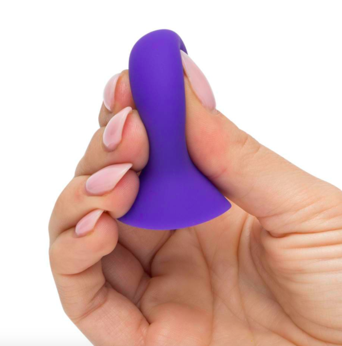 Model holds purple nipple sucker in their palm