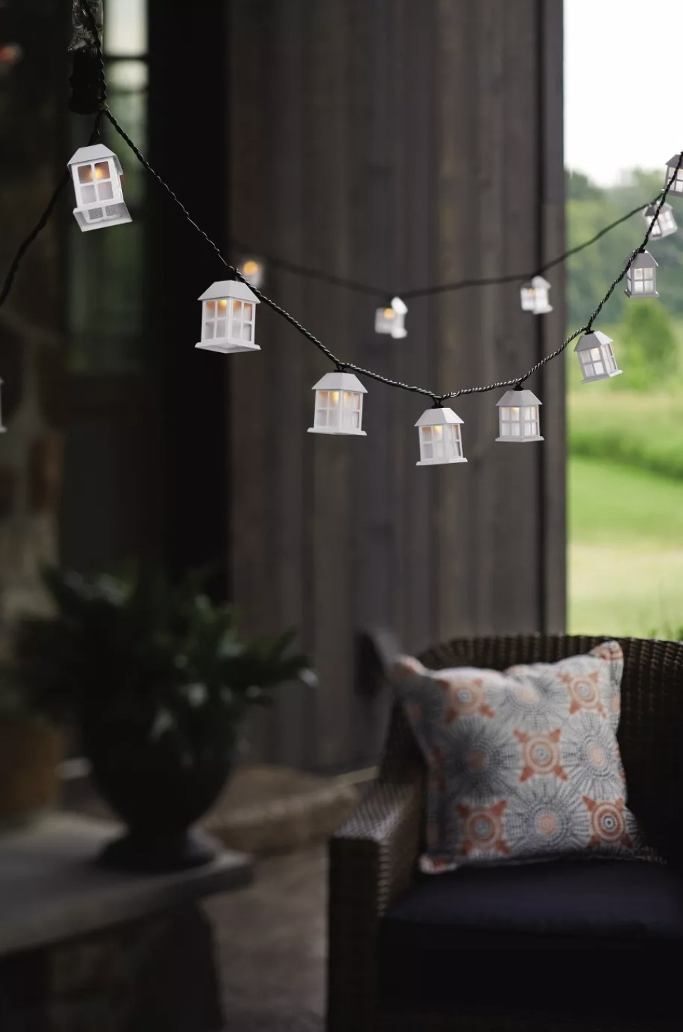 A string of lights that look like little lanterns with an unfocused background