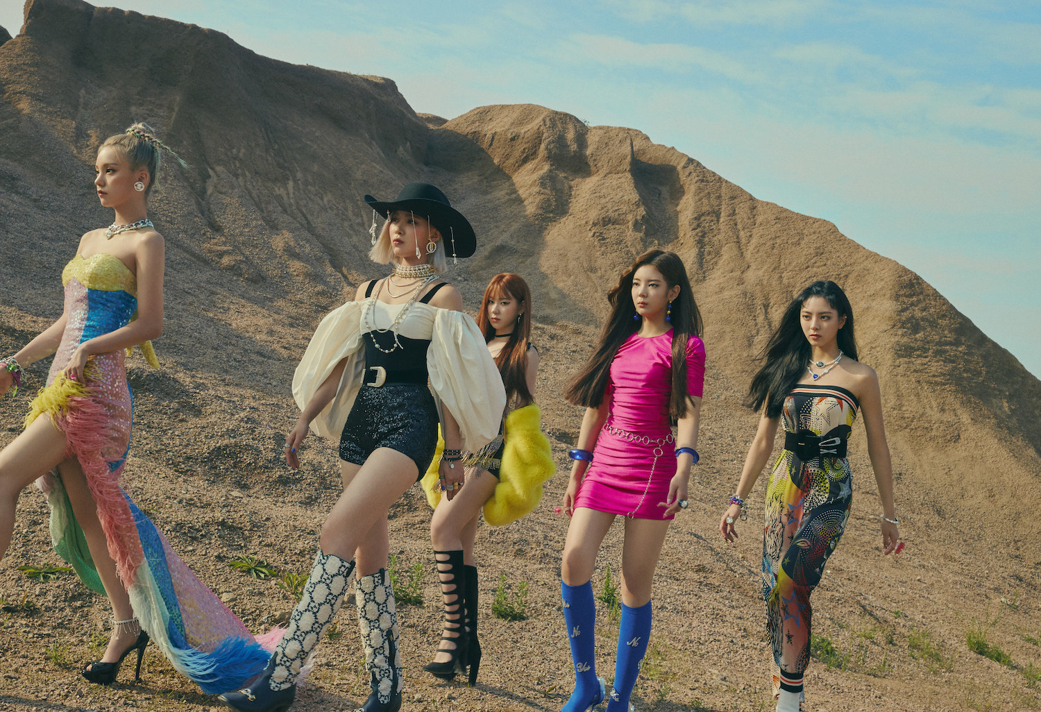 ITZY walks together through the desert in their high heels and dresses