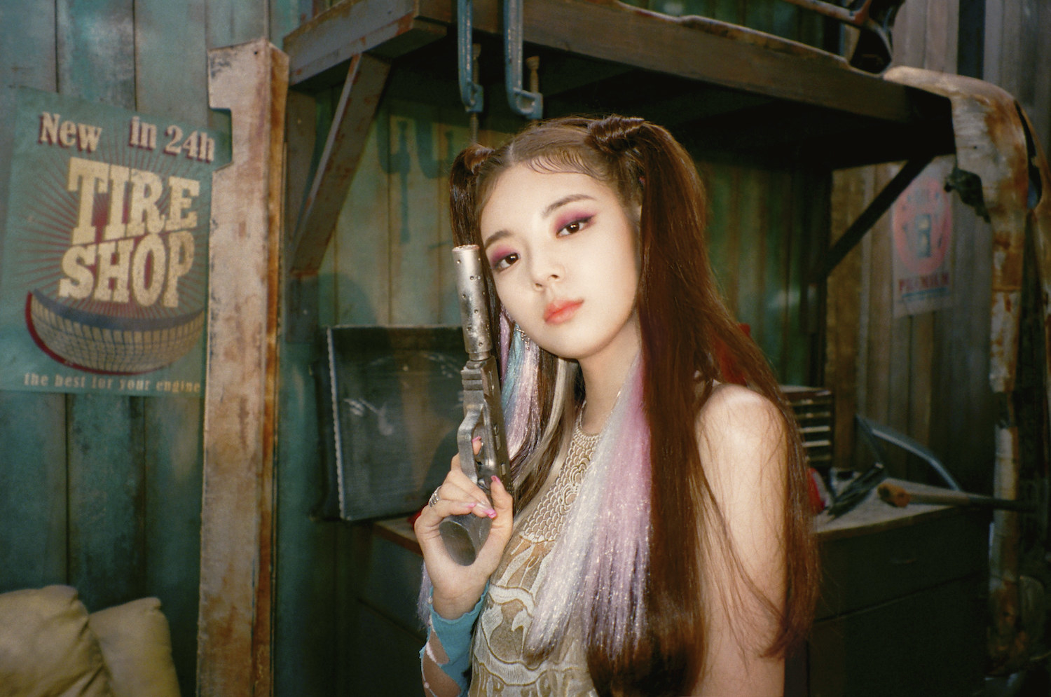 Lia poses with multi-colored hair extensions and two lop-sided ponytails 