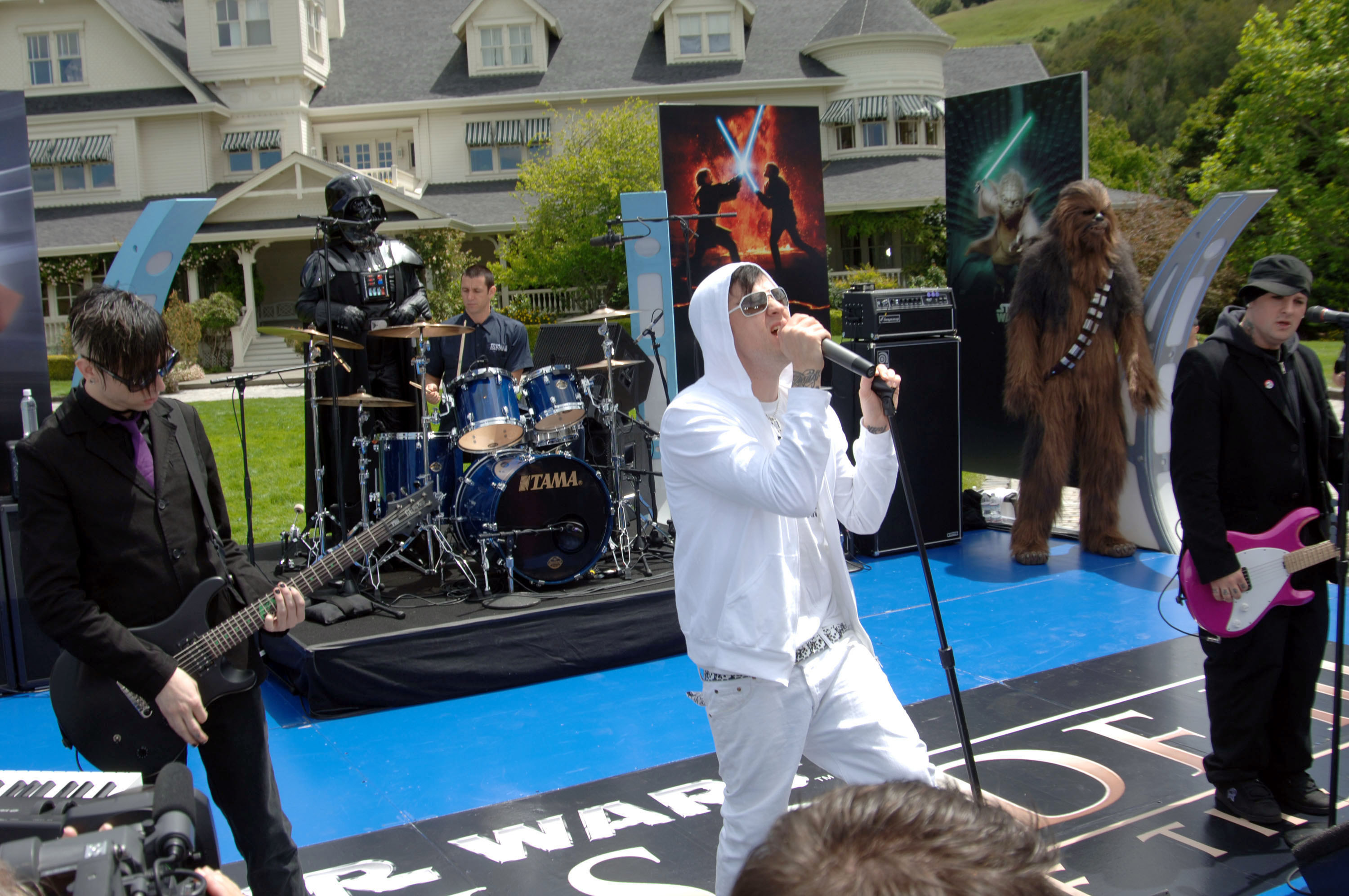 Good Charlotte performing outdoors at Lucas Ranch with Darth Vader and Chewbacca standing on stage with them.