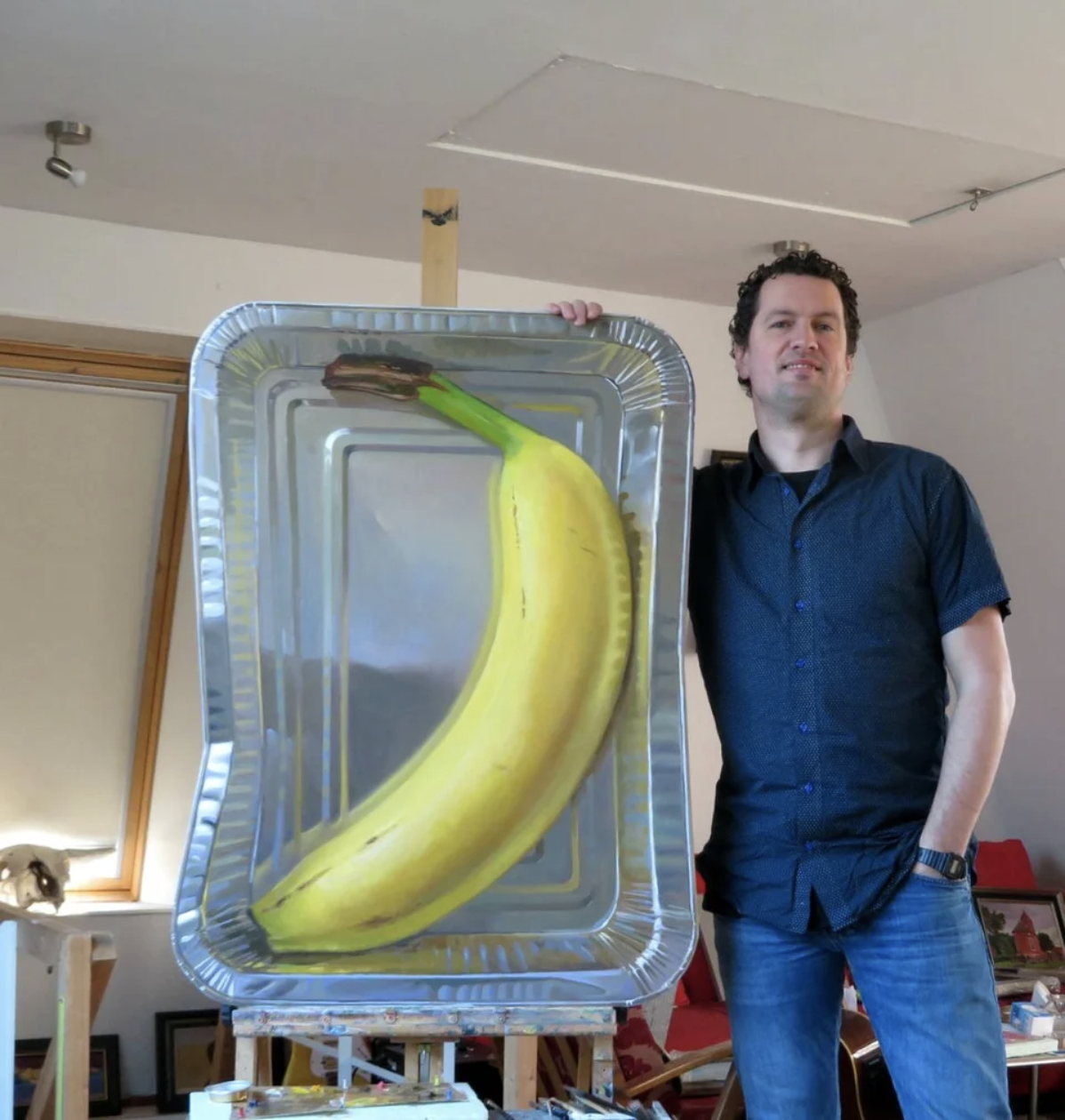 A man has painted a huge banana into a pan and it looks very real