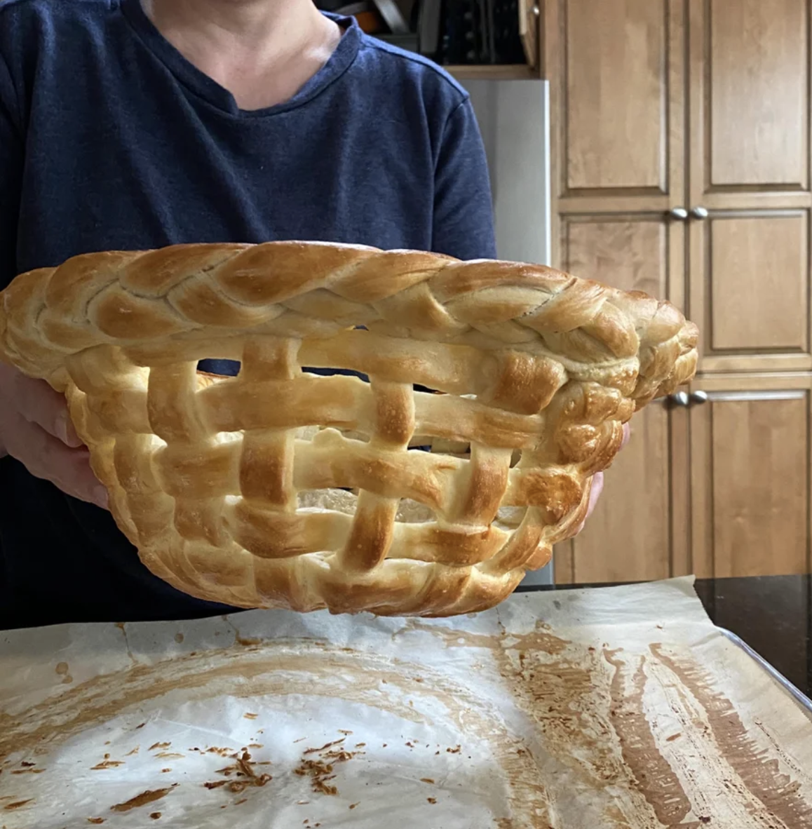 A woman holds an amazing basket made of bread