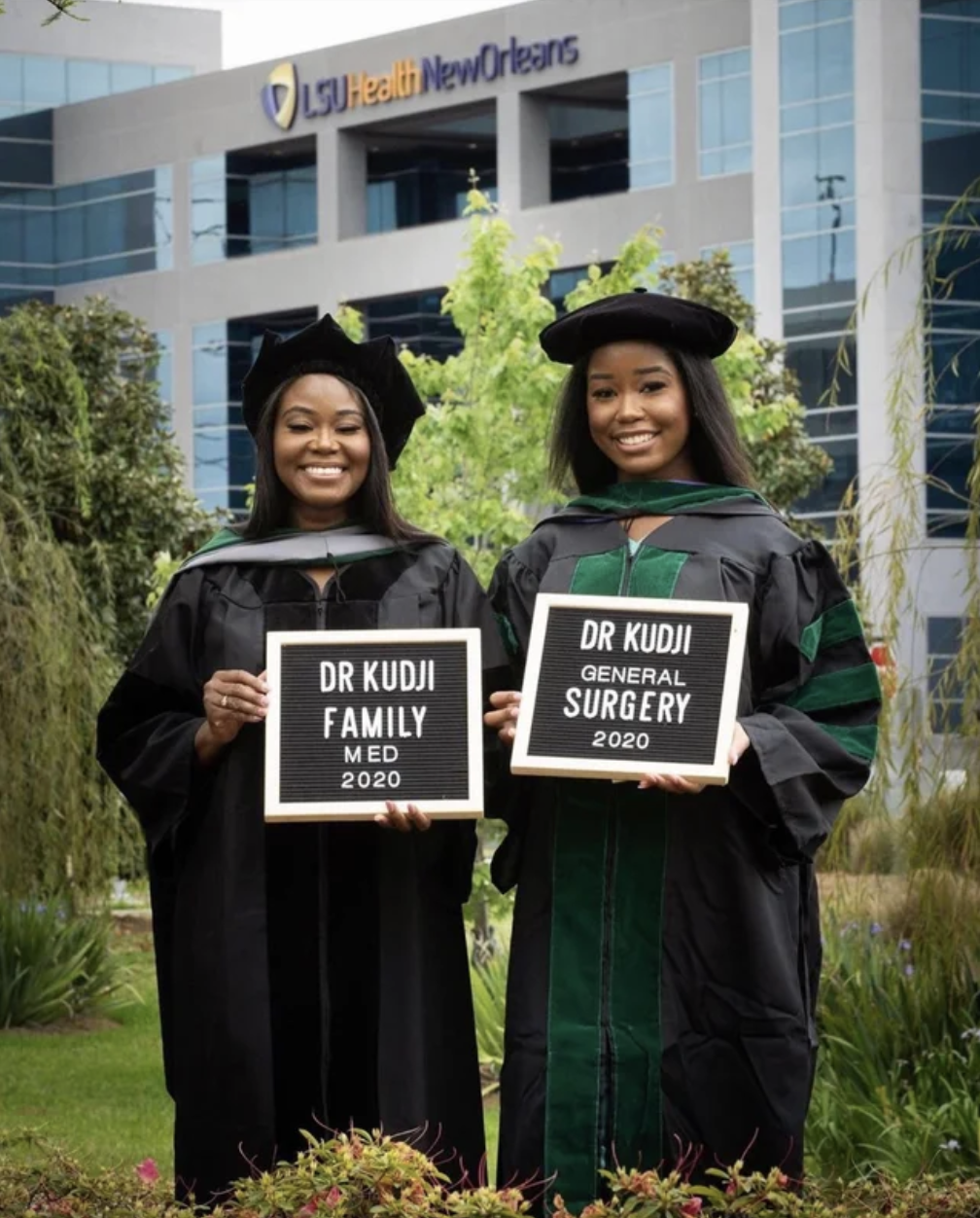 A mother and daughter each hold a diploma