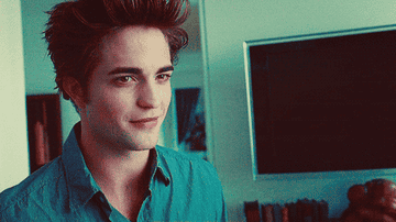 Gif of Edward Cullen standing in his room and smiling
