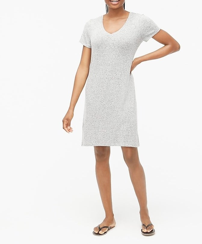 model in a light grey knee-length V-neck T-shirt dress