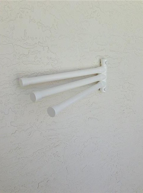 The white Outdoor Lamp Wall Mount 6 Bar Towel Rack on a wall