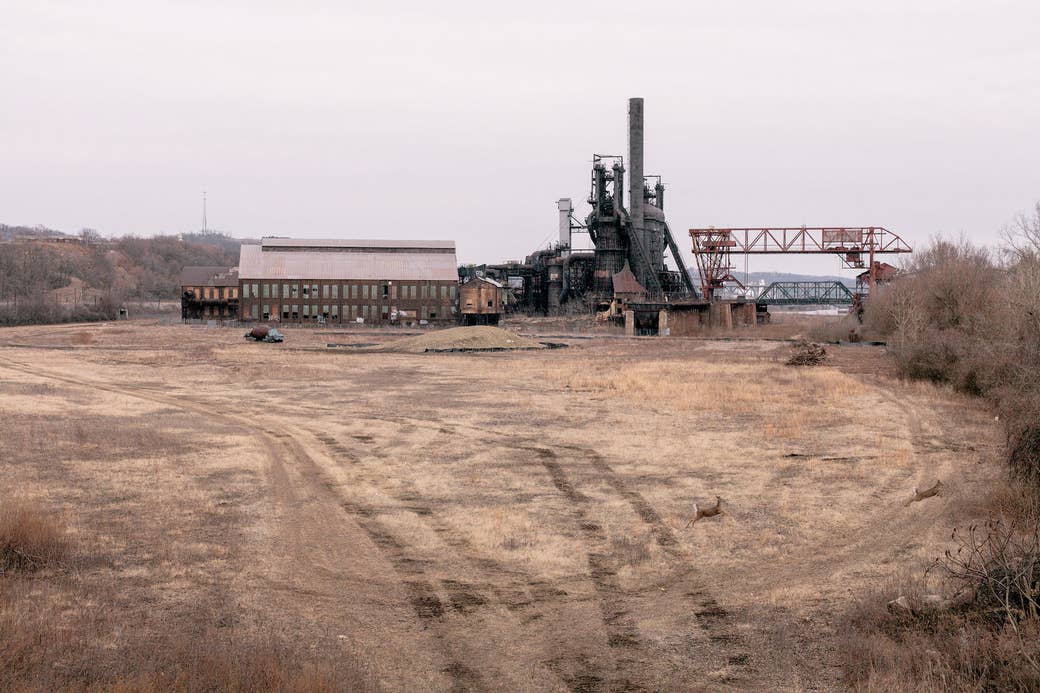 A desolate and abandoned industrial building under cloudy skies