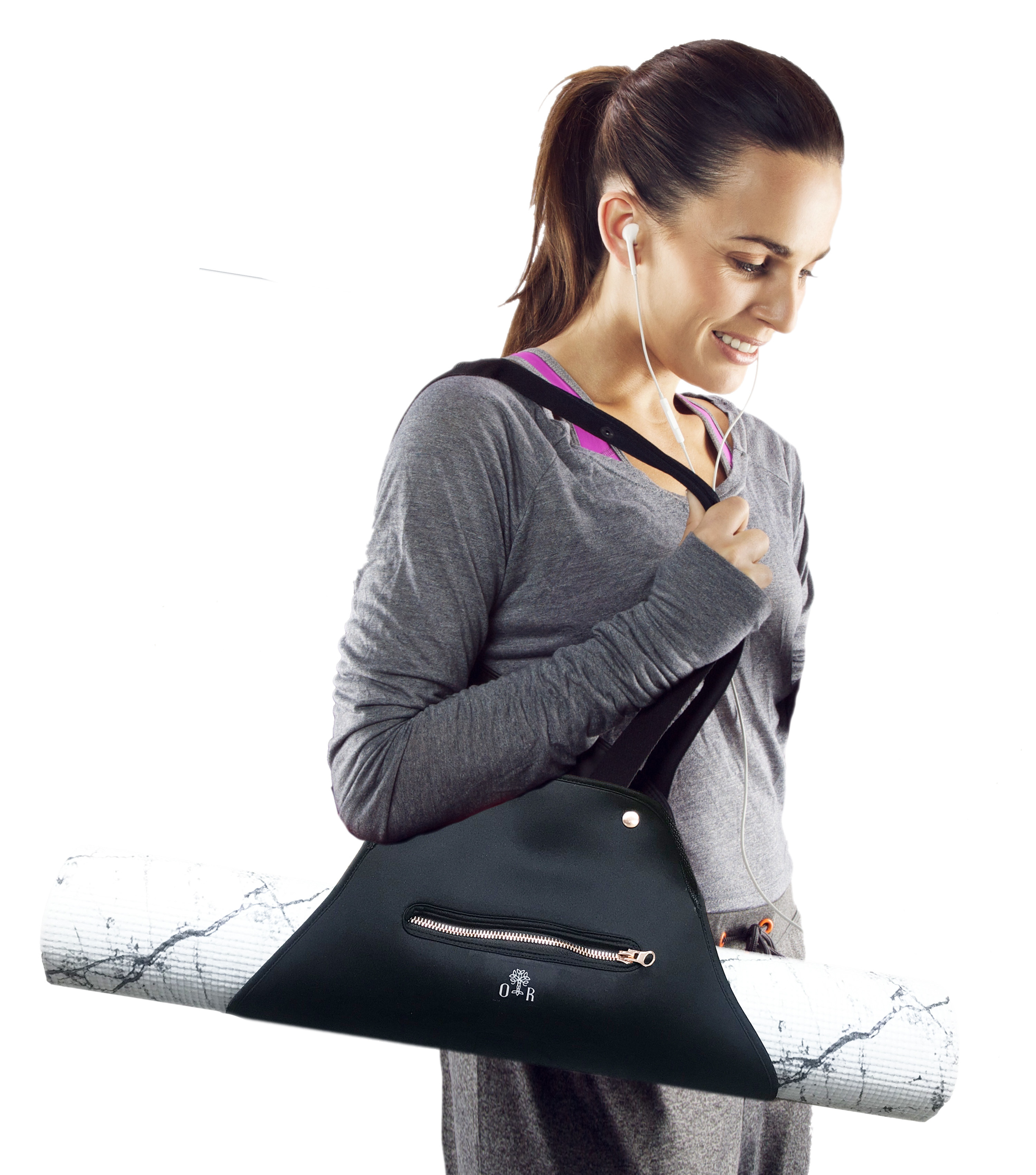 Model carrying a yoga mat in a black and rose gold yoga mat bag