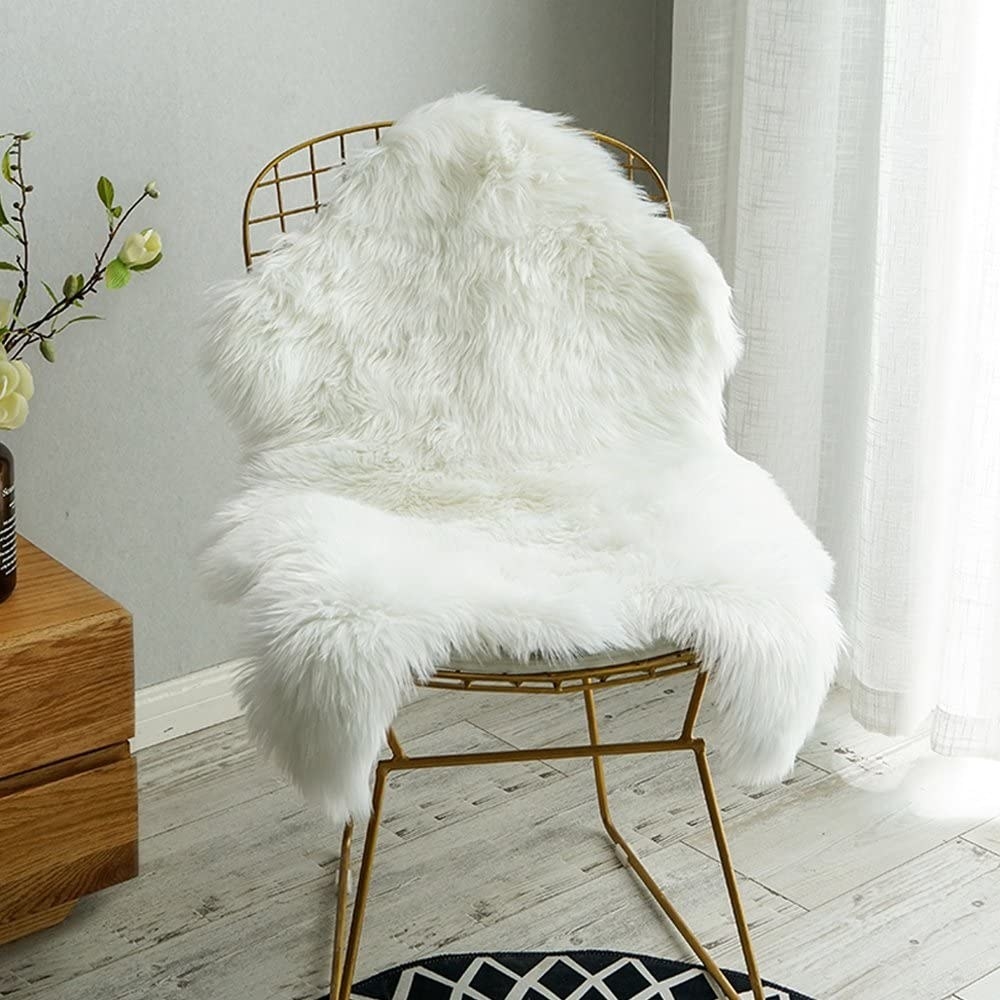 white faux fur rug thrown on a side chair