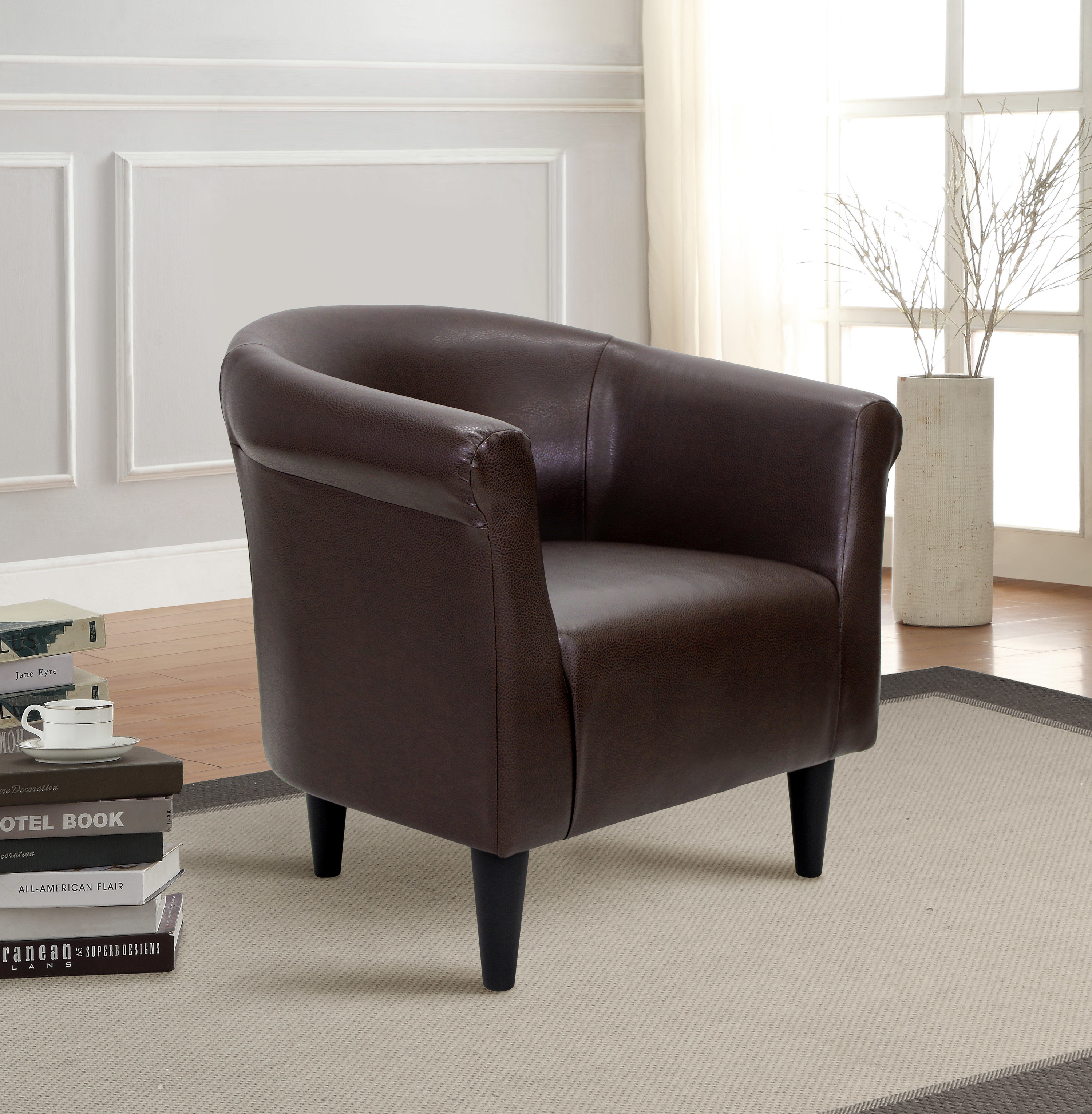 A dark brown faux-leather bucket chair 