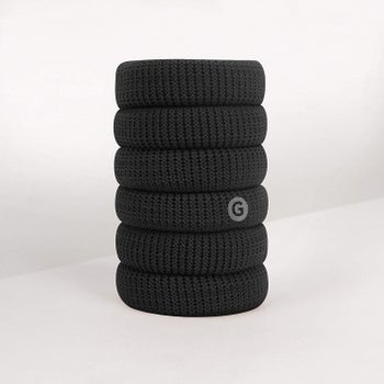 six black hair ties stacked on top of each other 
