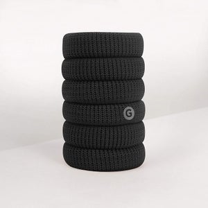 six black hair ties stacked on top of each other 
