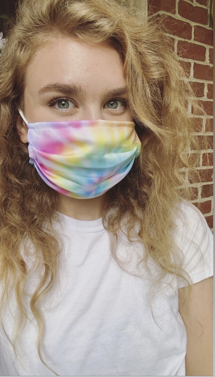 BuzzFeed editor in a rainbow tie dye face mask 