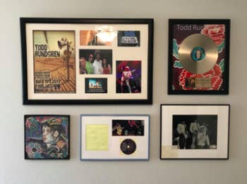 reviewer's pic of gallery wall of various sized framed items using the hanger