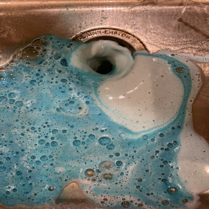 a reviewer's drain being cleaned by the product
