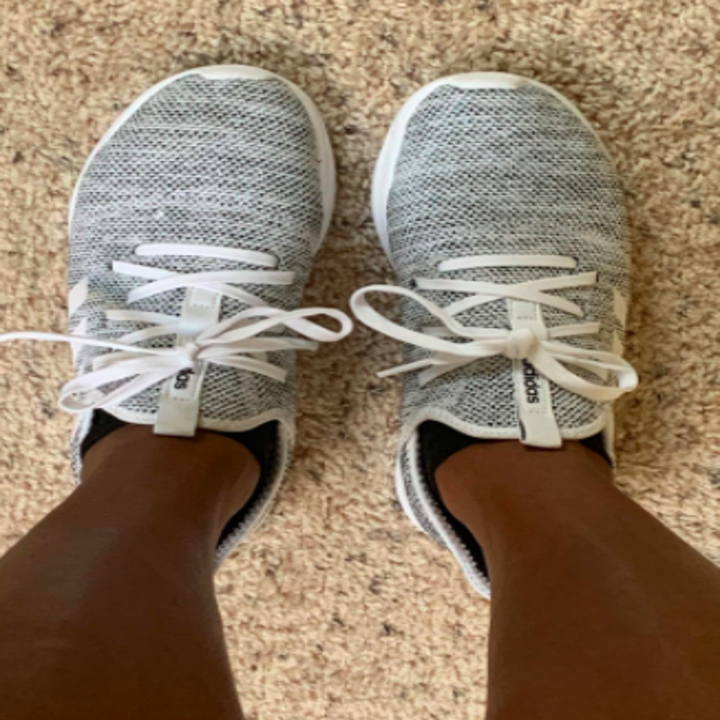Reviewer wears gray Adidas Cloudfoam running sneakers with white laces