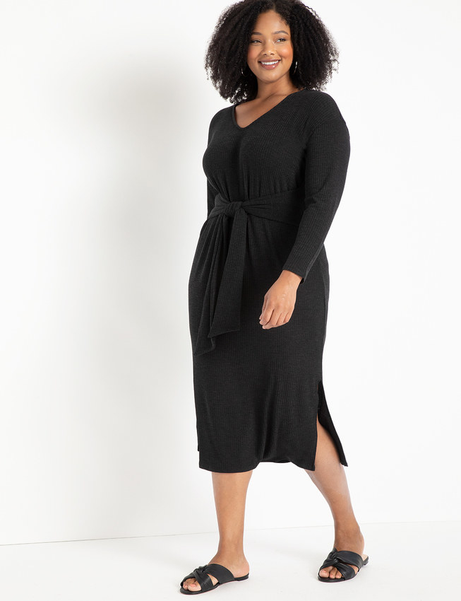 Model wearing the dress in black with tie around the middle and small slits up the side