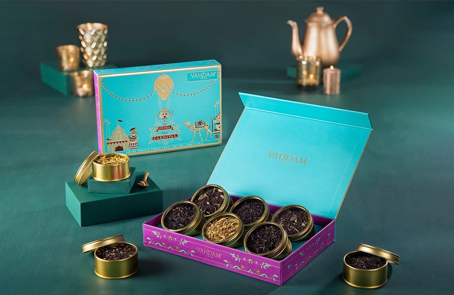 The six teas in small gold circular cans displayed in a box
