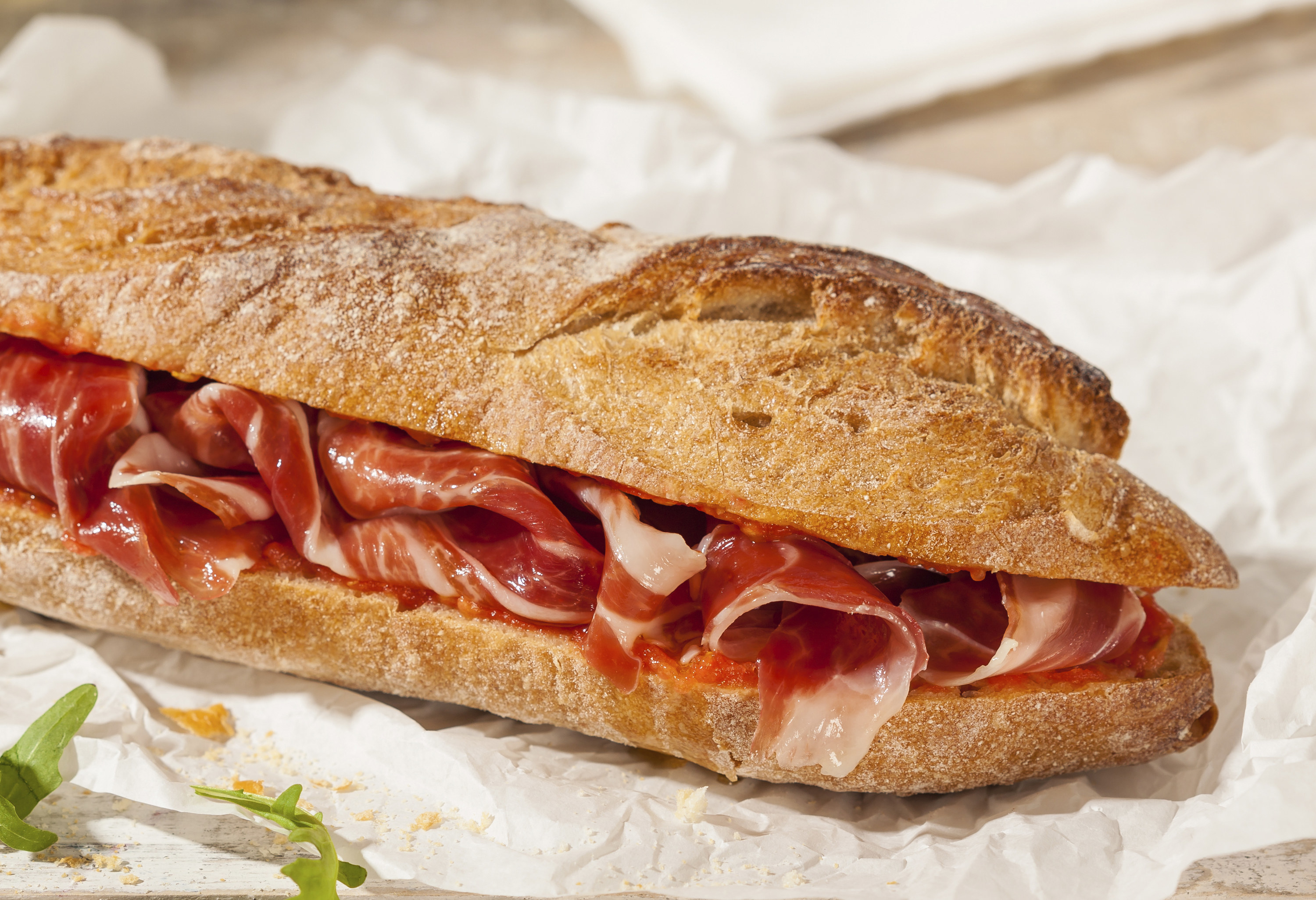 crusty baguette filled with generous amounts of thinly sliced jamon (ham)