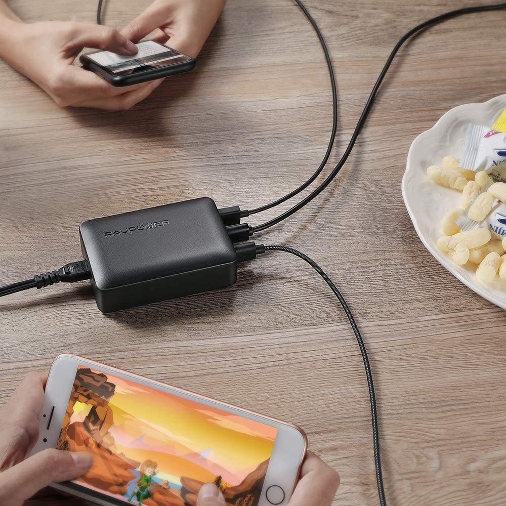 The USB charging hum with three cords plugged into it