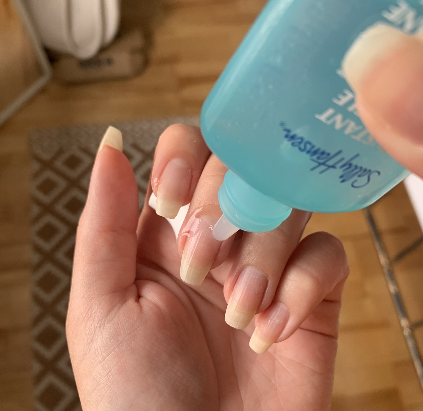 A person applying the cuticle gel