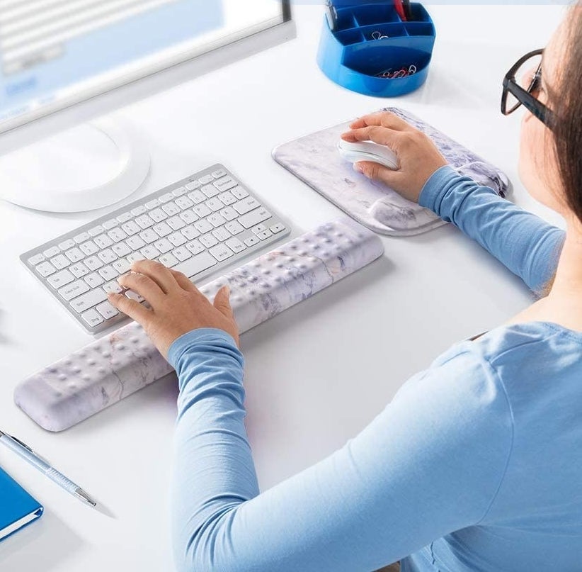 A person using both wrist rests while on their computer