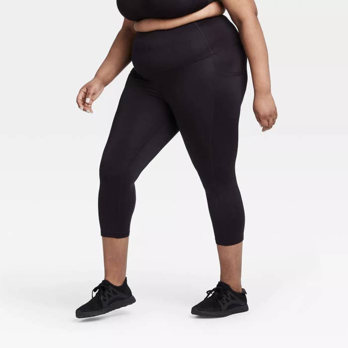 Model wearing black capri leggings