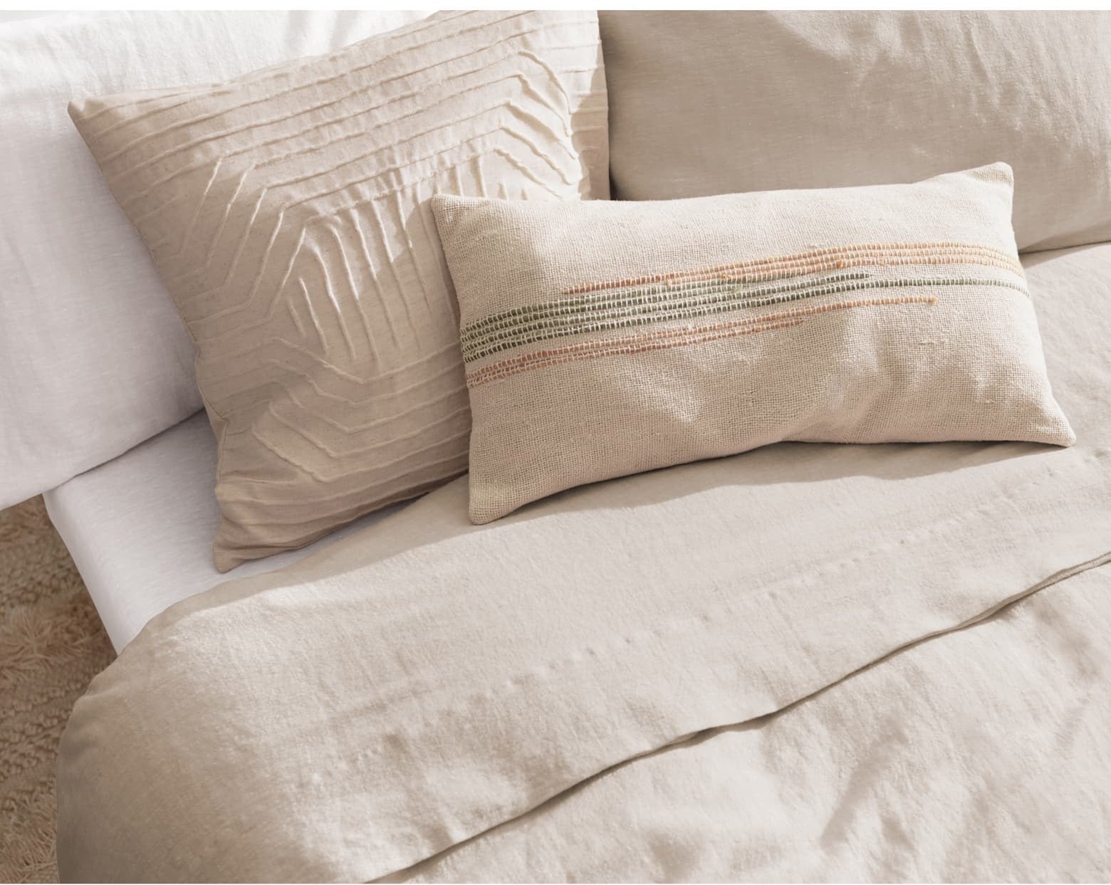 The duvet color in tan on a bed with pillows on it
