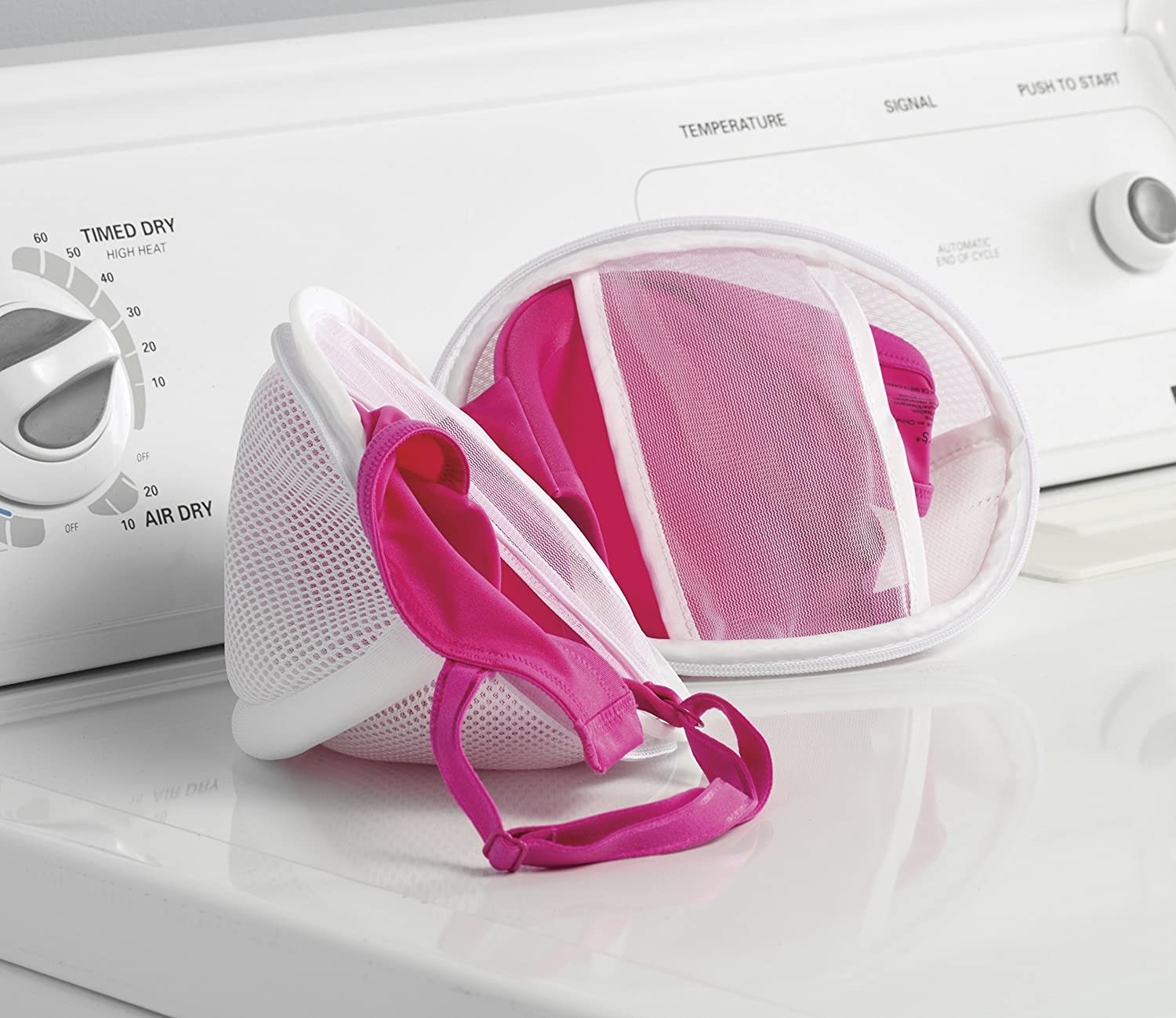 The wash bag filled with two bras and placed on a washing machine