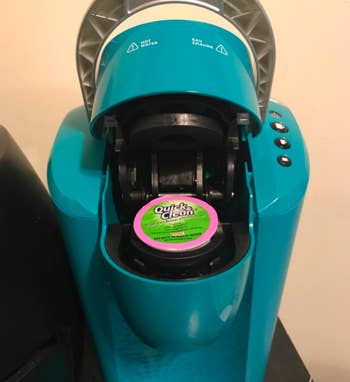 A customer review photo of their Keurig with a cleaning cup in it