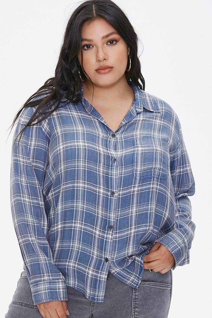 Model wearing blue plaid shirt with a button front, basic collar, and long sleeves