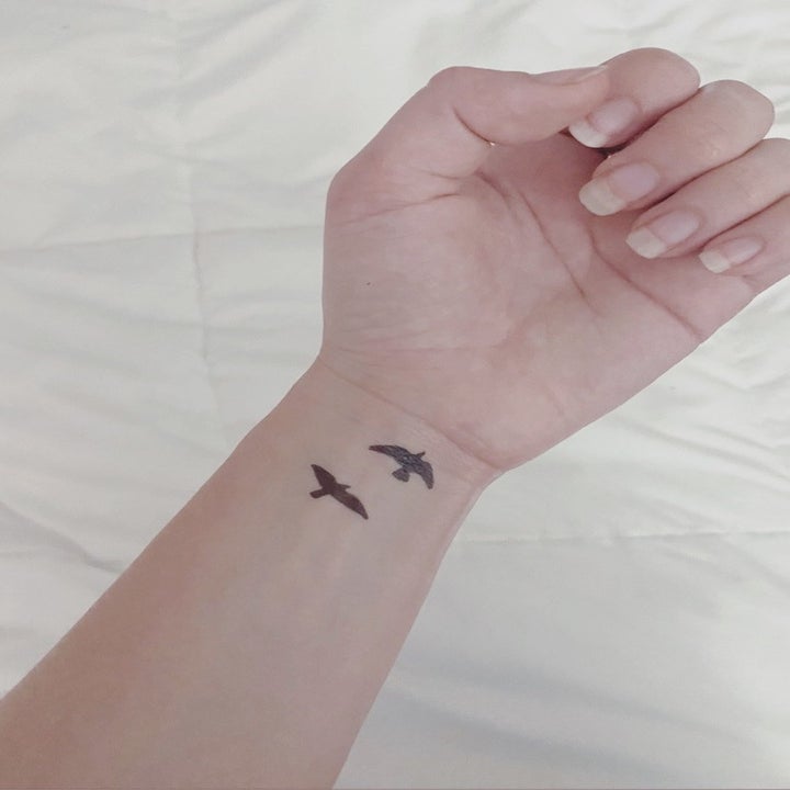 BuzzFeed editor's wrist with two birds temporarily tattooed 