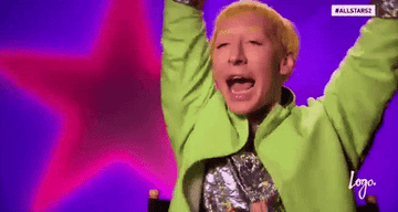 Gif of contestant from RuPaul&#x27;s Drag Race waving their arms in excitement 