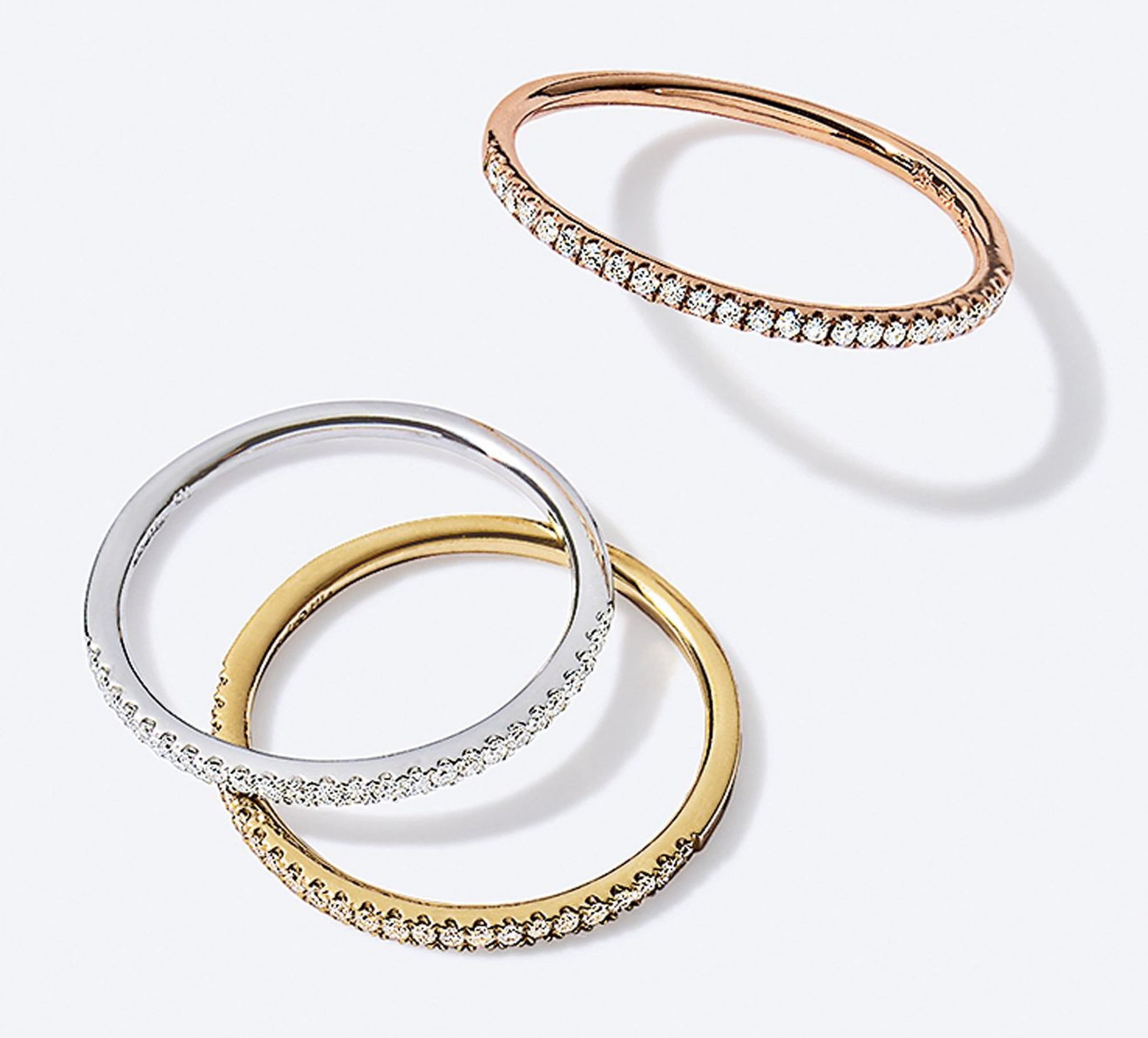 A flatlay of three rings, one in each metal tone