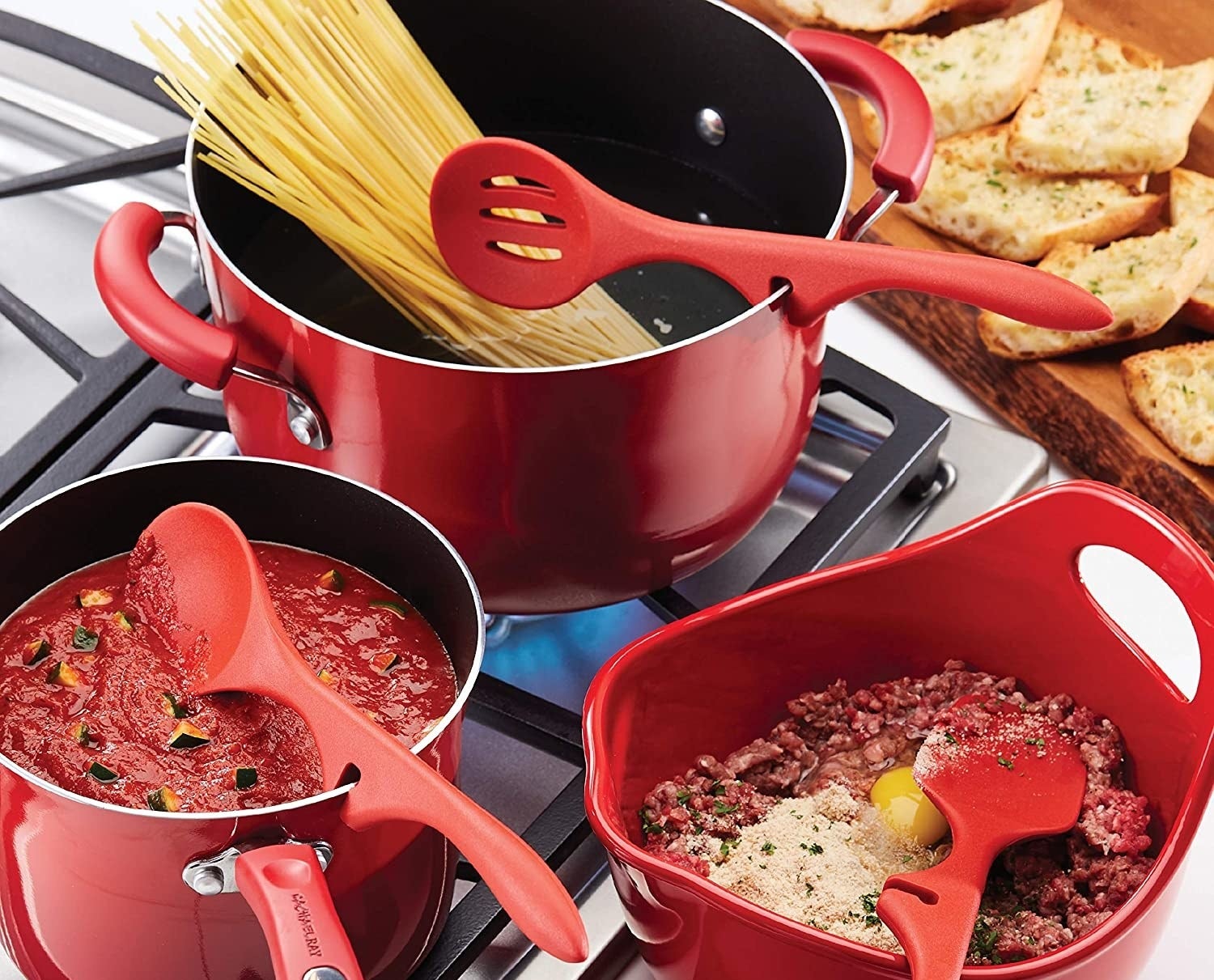 Three non-stick utensils clipped onto pots and pans