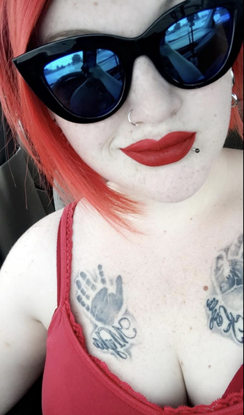 Reviewer in black cat eye sunglasses with reflective frames 