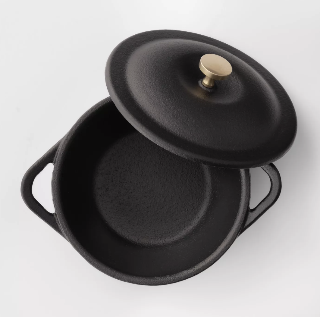 A black mini cast iron Dutch oven 