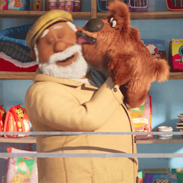 A gif from The Secret Life of Pets of a man being licked on the face by a puppy