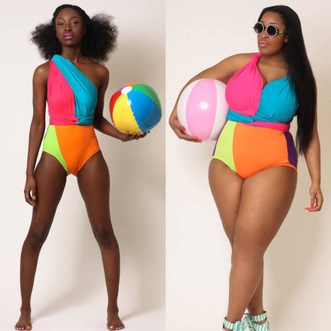 Two models wearing the blue, orange, pink, purple, and yellow one-piece suit different ways. One is wearing it in a one-shoulder style while the other has the straps tied into a sweetheart neckline