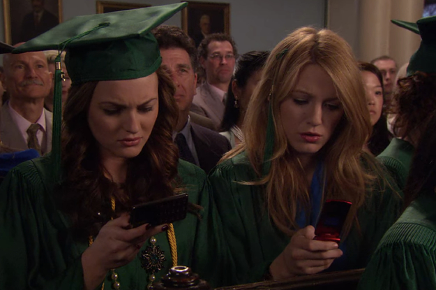 Blair and Serena staring at their phones at graduation in
