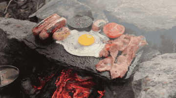 Cooking breakfast on a rock