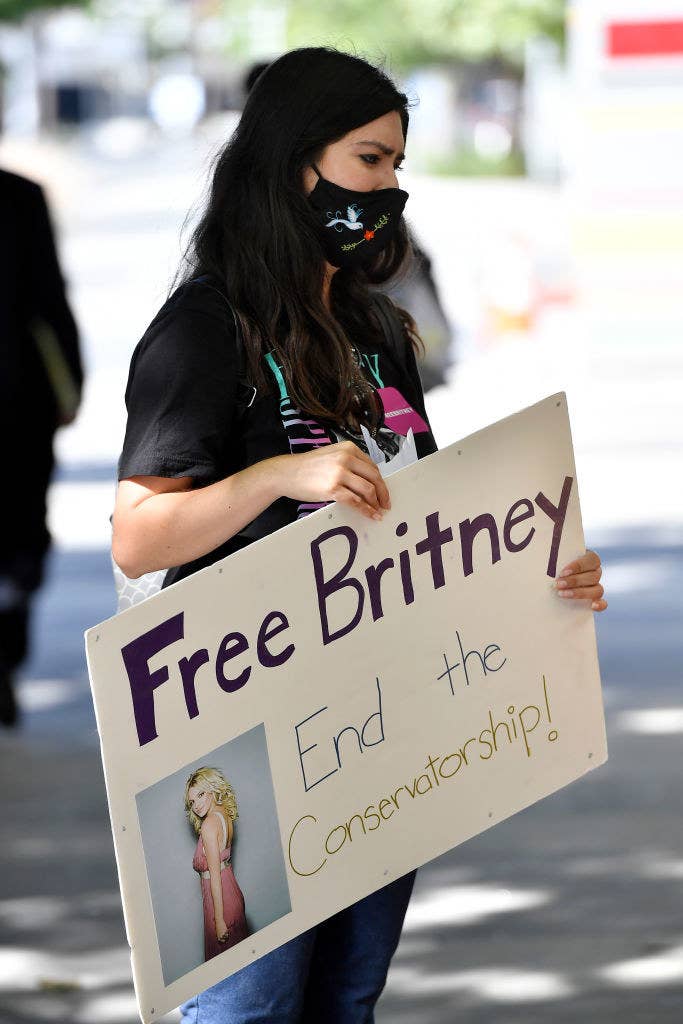 A protestor holding a sign that says &quot;Free Britney, end the conservatorship!&quot;