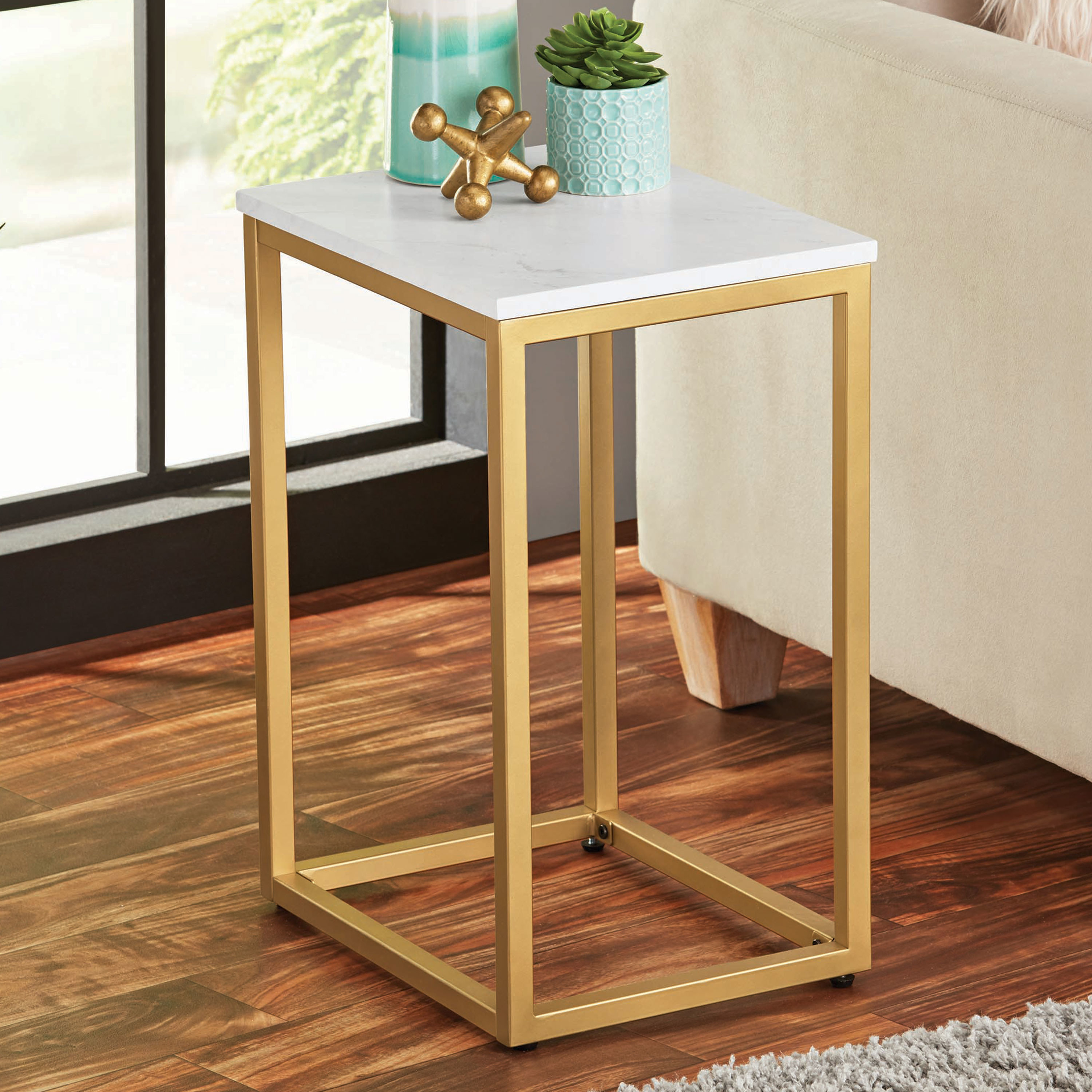 the gold table with a white marble top