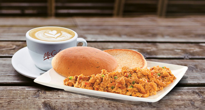 Image of McDonald&#x27;s coffee along with masala scrambled eggs and some toasted, buttered buns.