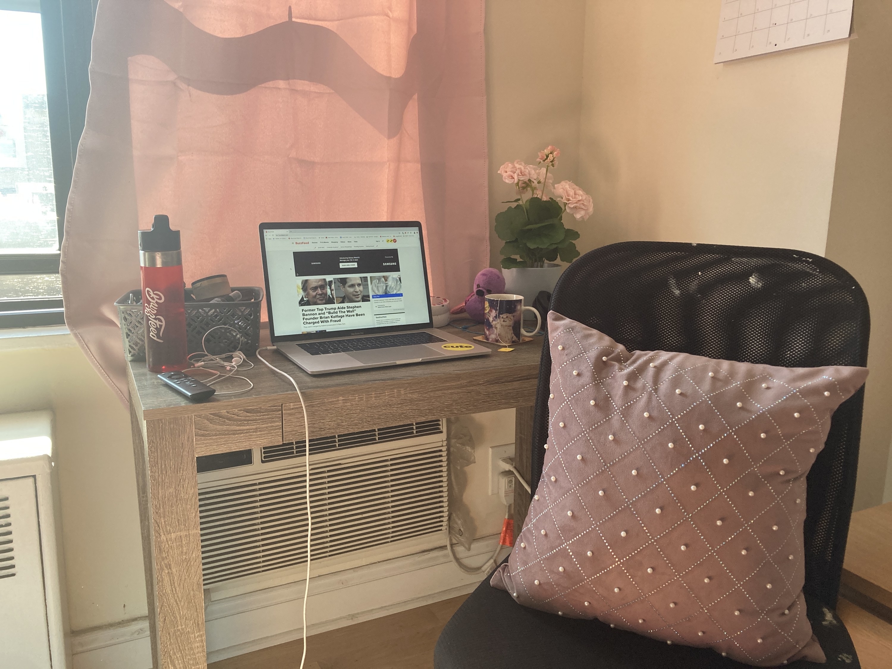 The writer&#x27;s desk, which now has a laptop placed on it next to the fake flowers